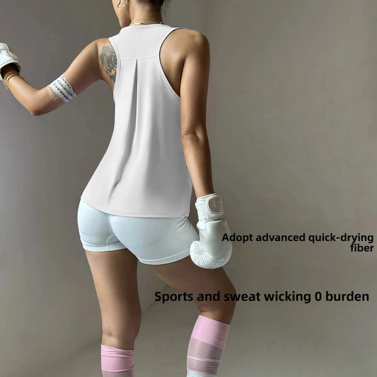Back view of woman wearing KiKis women's quick dry yoga top and white shorts with boxing gloves